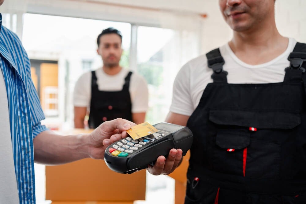 A customer paying a tradesmen by credit card