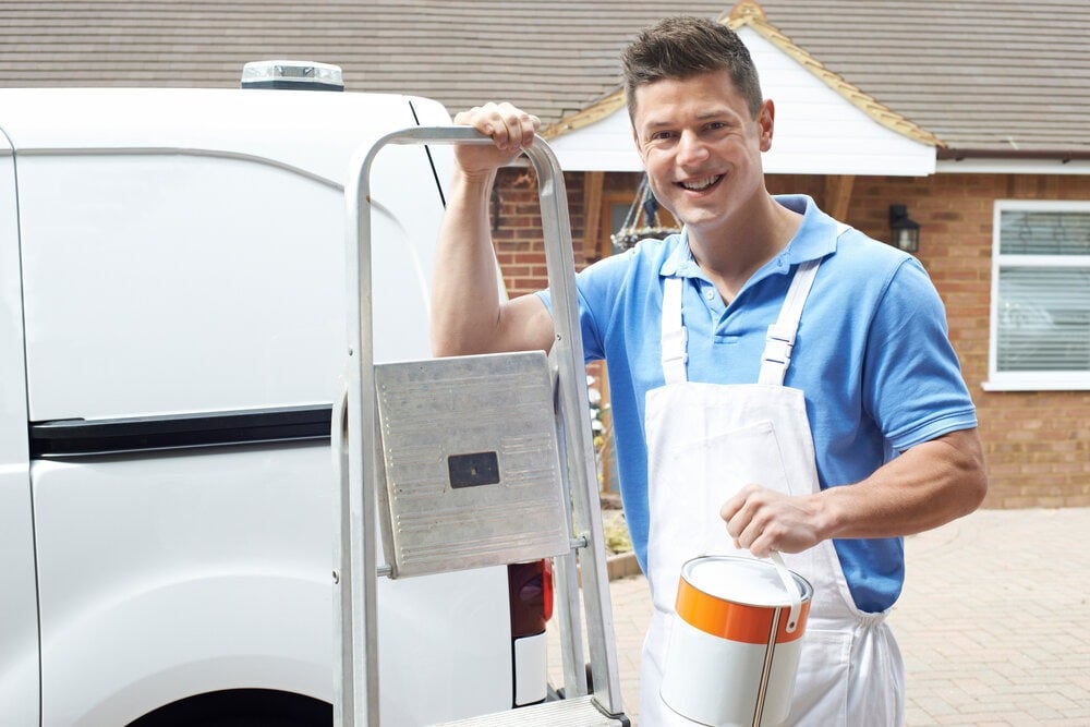 A painter and decorator in front of his van