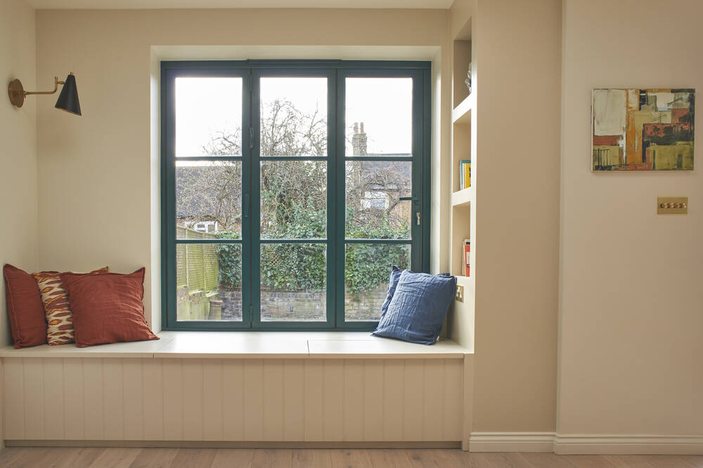 A green window with a bench underneath